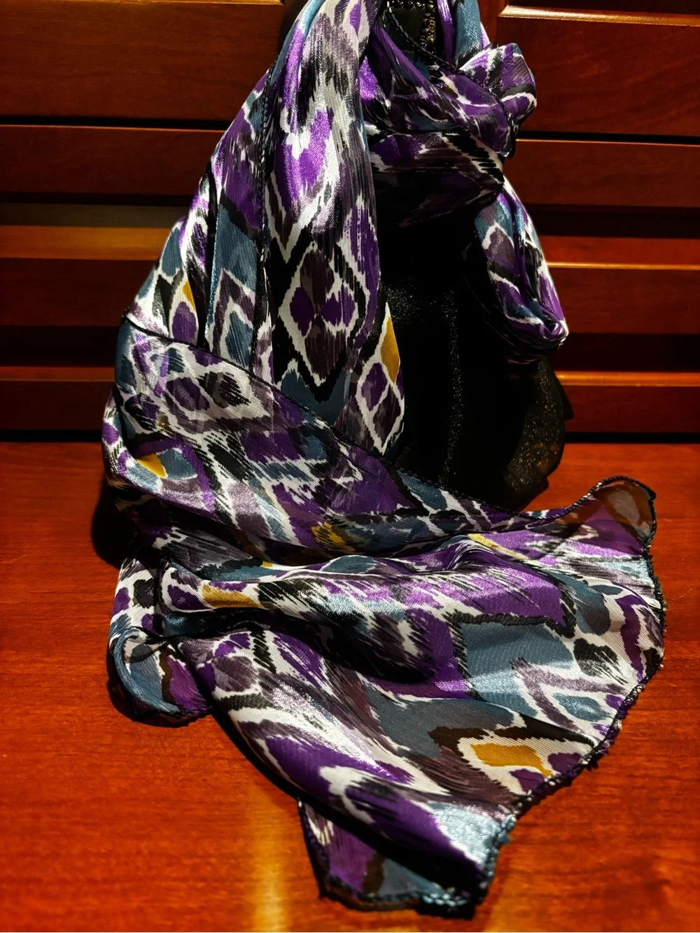 satin scarf featuring a vibrant purple and teal abstract ikat chevron